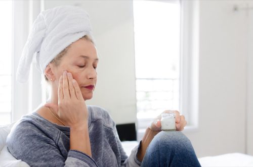 woman putting on lotion