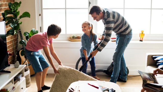 man and two children cleaning living room, earth friendly cleaning products