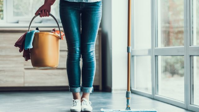 woman holding cleaning bucket, essential home supplies