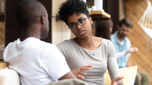 black man and woman talking outdoors