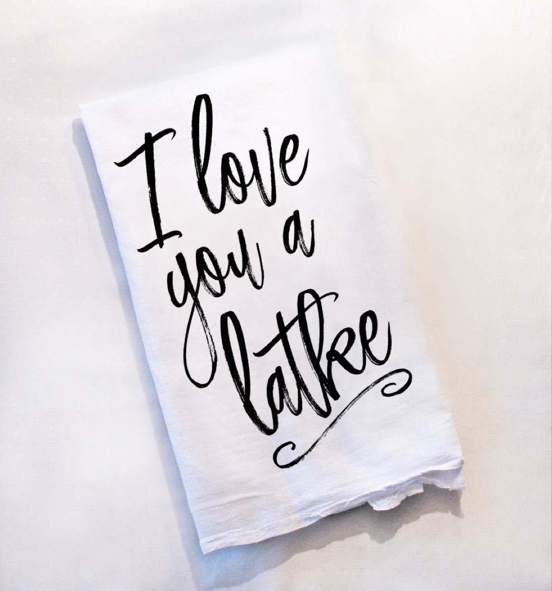 white dish towel with "I love you a latke" on it, hanukkah decorations