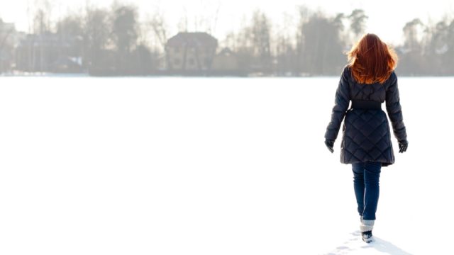redheaded woman walking in snow