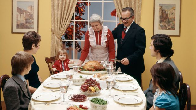 1970s THREE GENERATION FAMILY HAVING THANKSGIVING DINNER