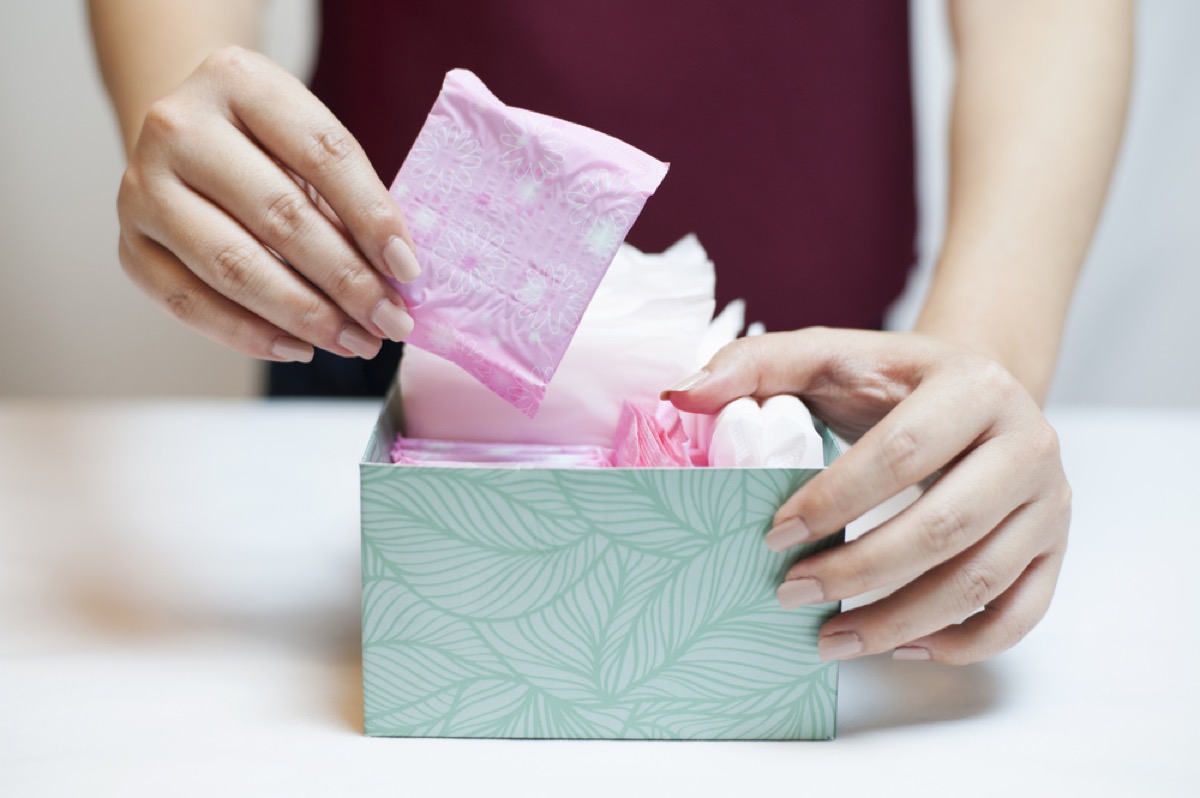 white woman removing pad from box