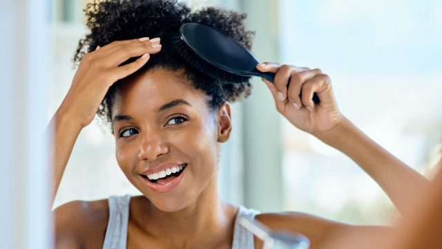 smiling-woman-brushing-her-hair