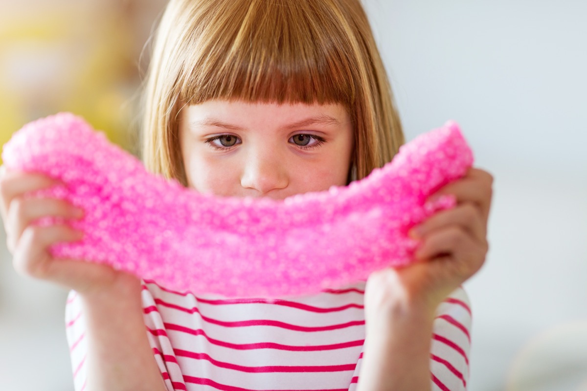 little girl playing with slime