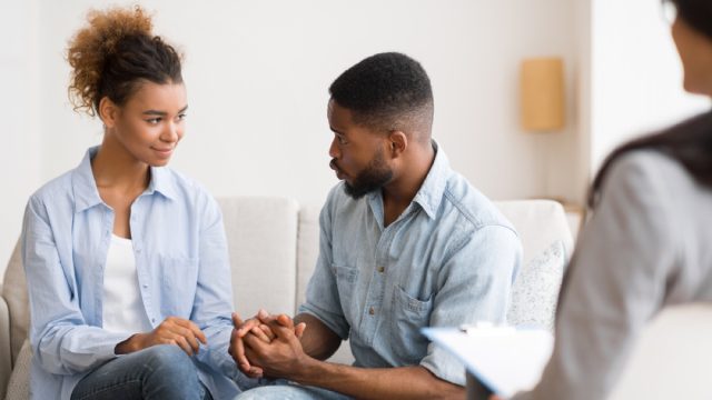 black couple holding hands at couples therapy