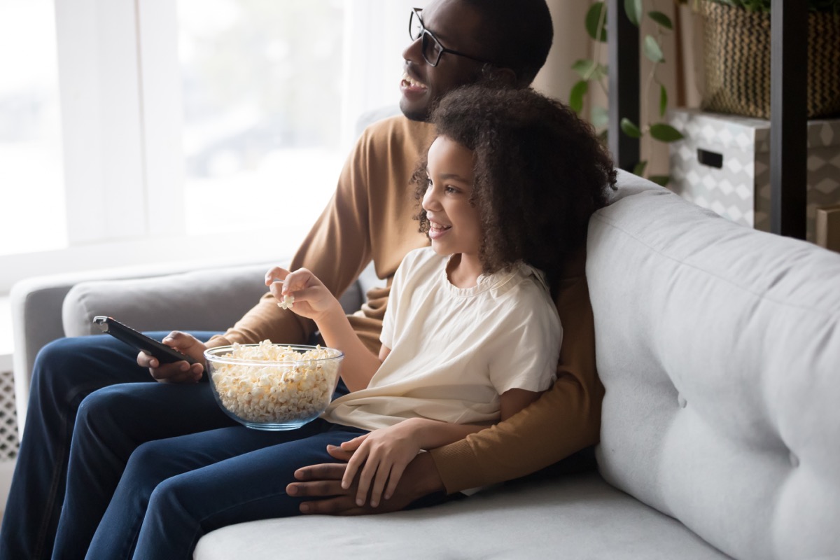 black father and daughter watching movie