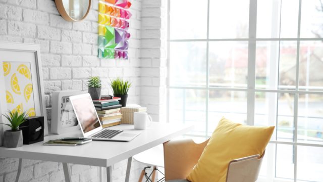 modern office with yellow pillow on white chair