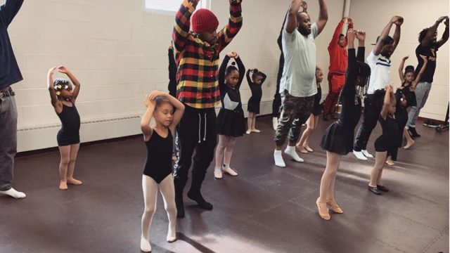 group of black fathers dancing with their daughters at ballet studio