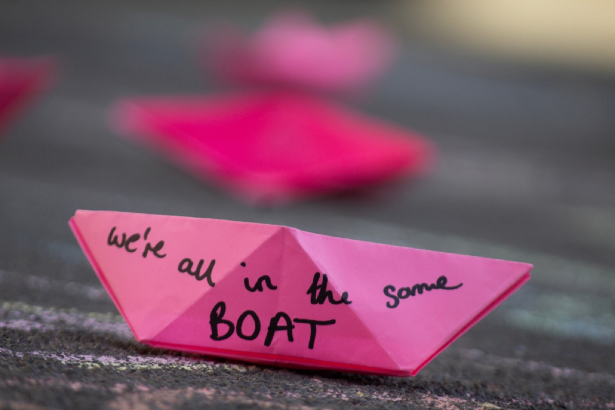 plastic ban protests in Oxford Circus in London show little pink boats that read "we're all in the same boat"