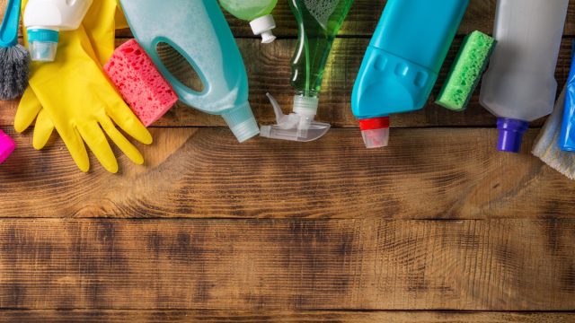 various cleaning products on wooden table