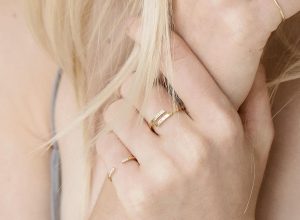 Blonde woman wearing wrap name ring