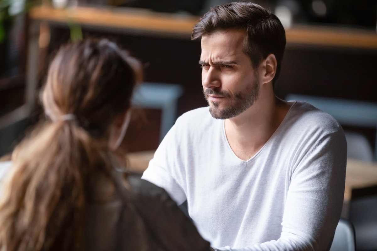 Doubting dissatisfied man looking at woman