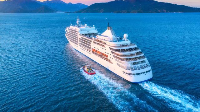a cruise ship sails into the sunset