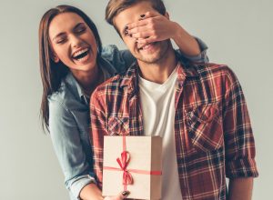 Girl surprising guy with gift