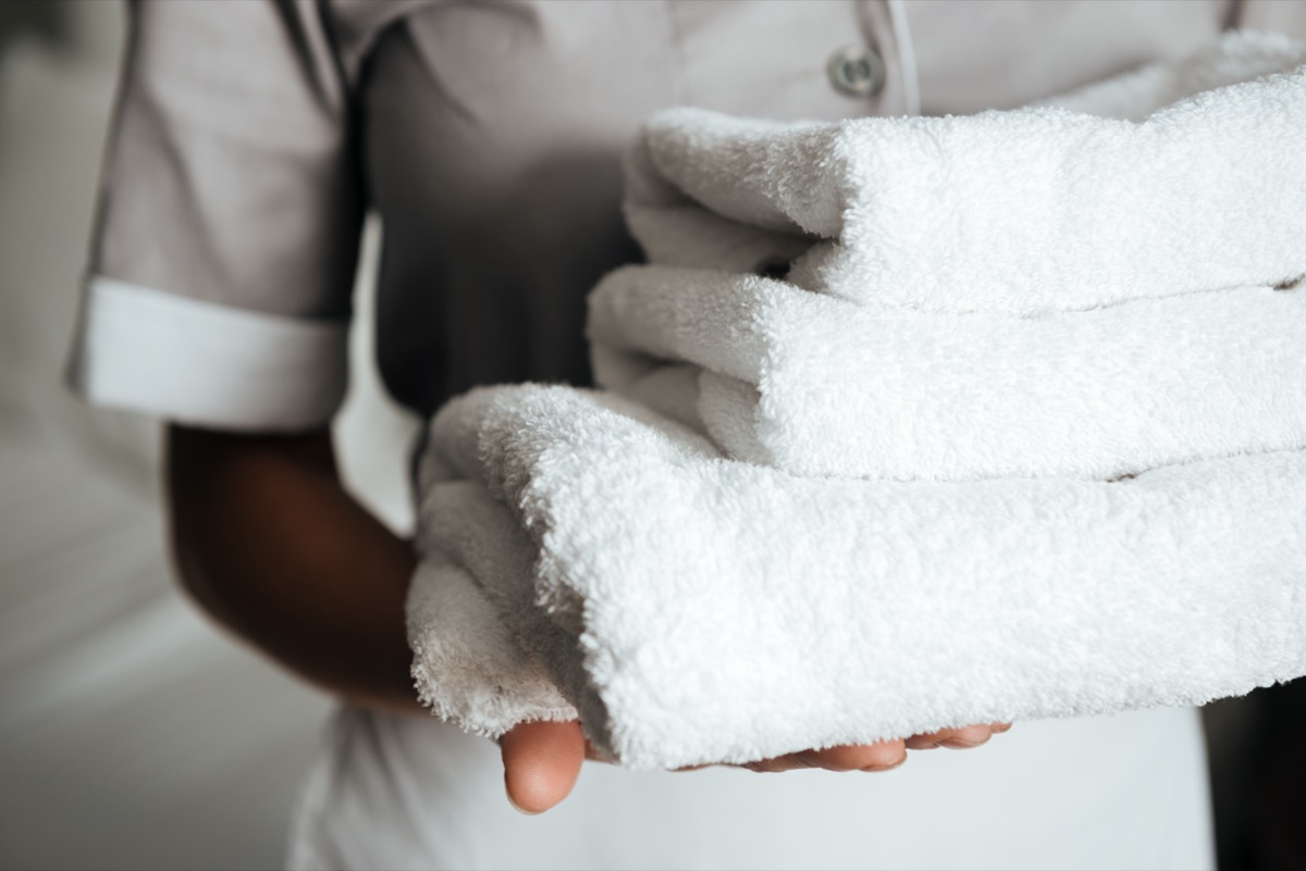 hotel maid carrying clean laundry