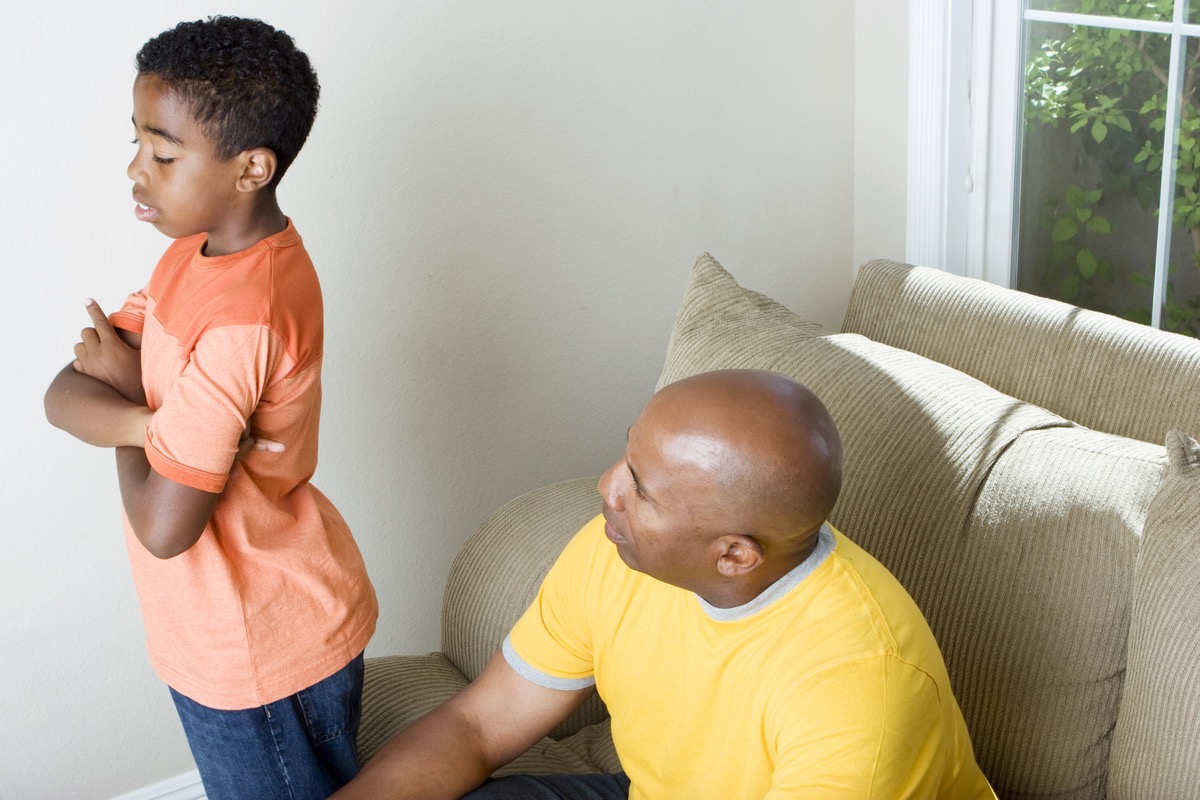 black man scolding grandson