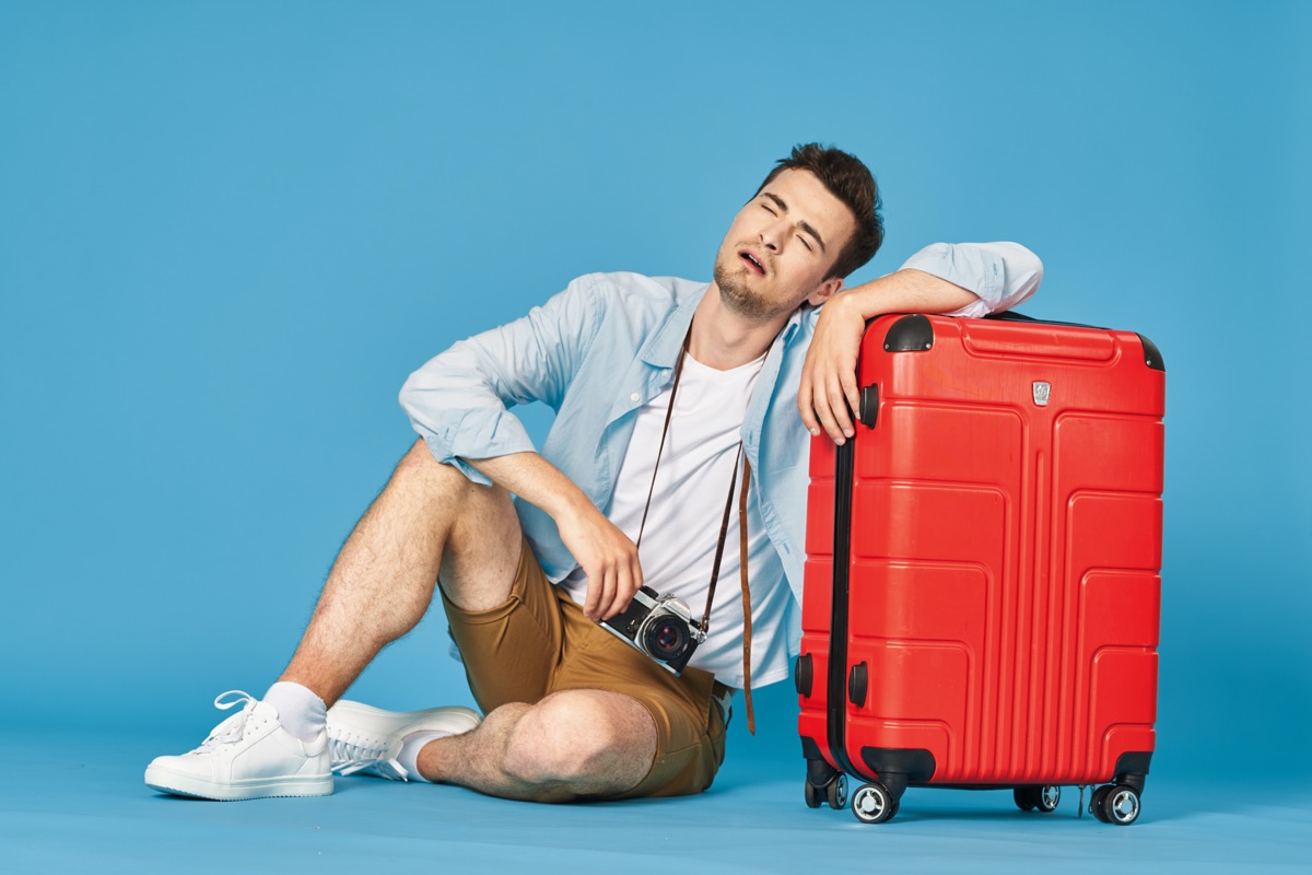 man sitting with his luggage