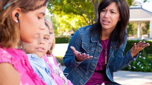Distraught mother with her kids listening to music