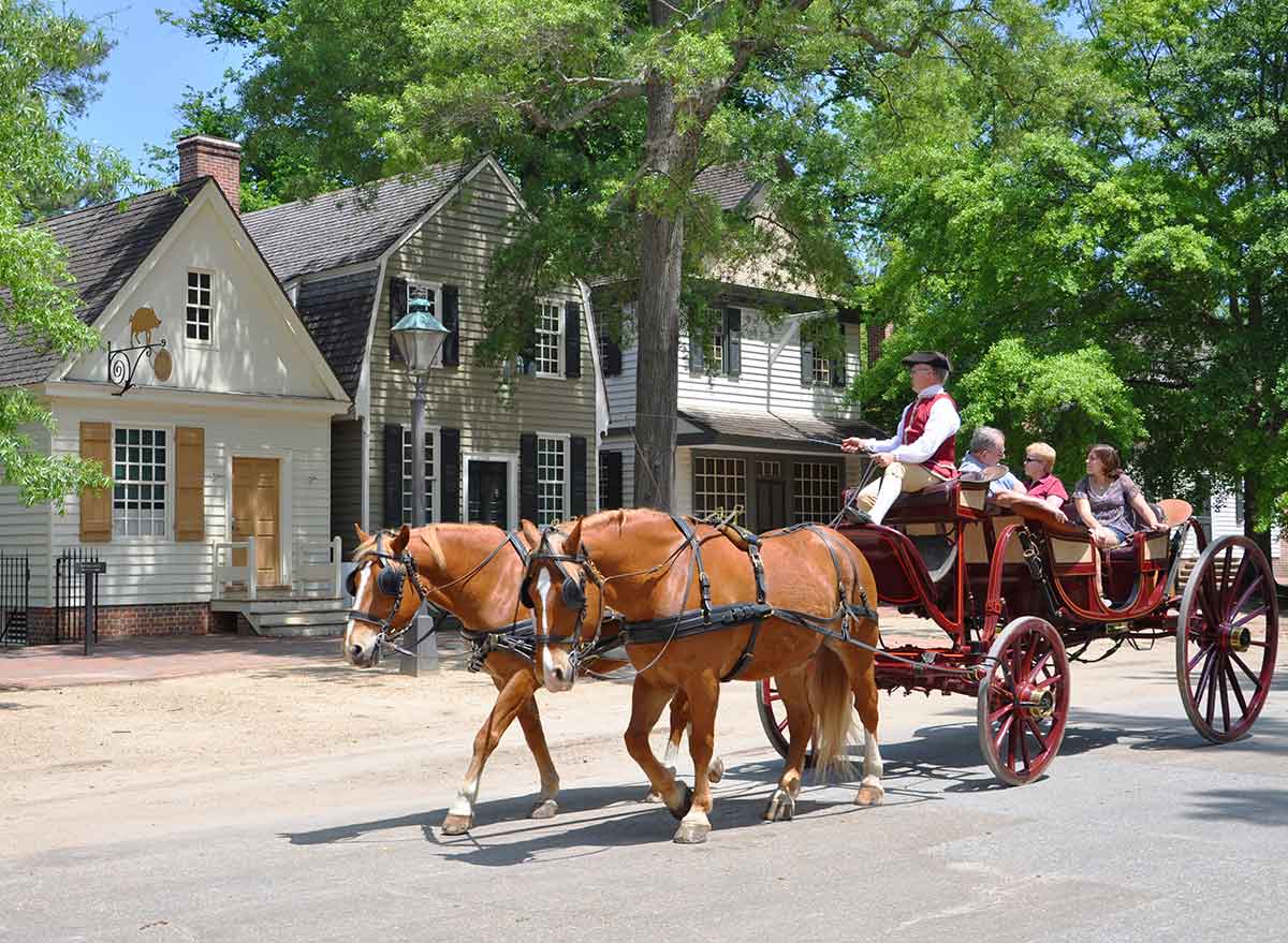 a horse and carriage of tourists in colonial williamsburg