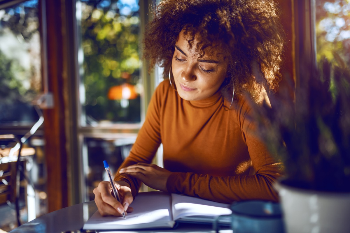 Portrait of cute mixed race student with curly hair and in turtleneck sitting in cafe and studying for exams. (Portrait of cute mixed race student with curly hair and in turtleneck sitting in cafe and studying for exams., ASCII, 110 components, 110 by
