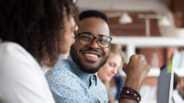 young black man smiling at woman