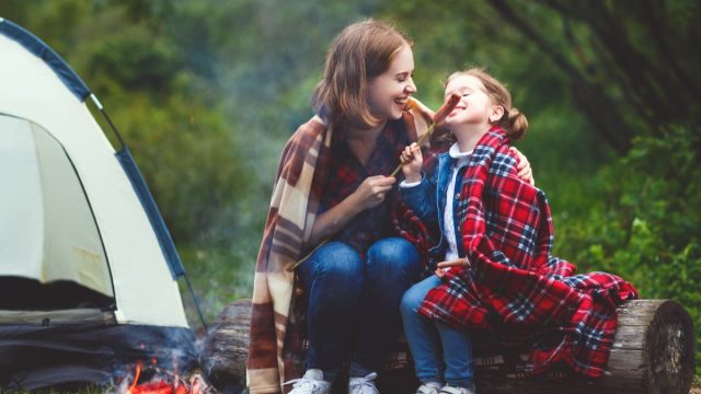 Mother daughter campfire roasting