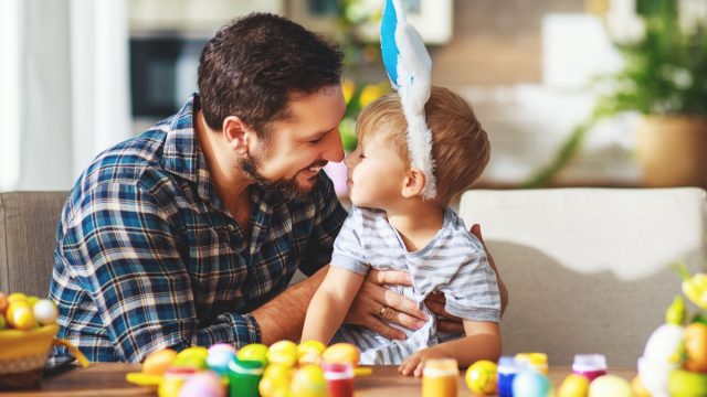 Father and son dyeing Easter eggs