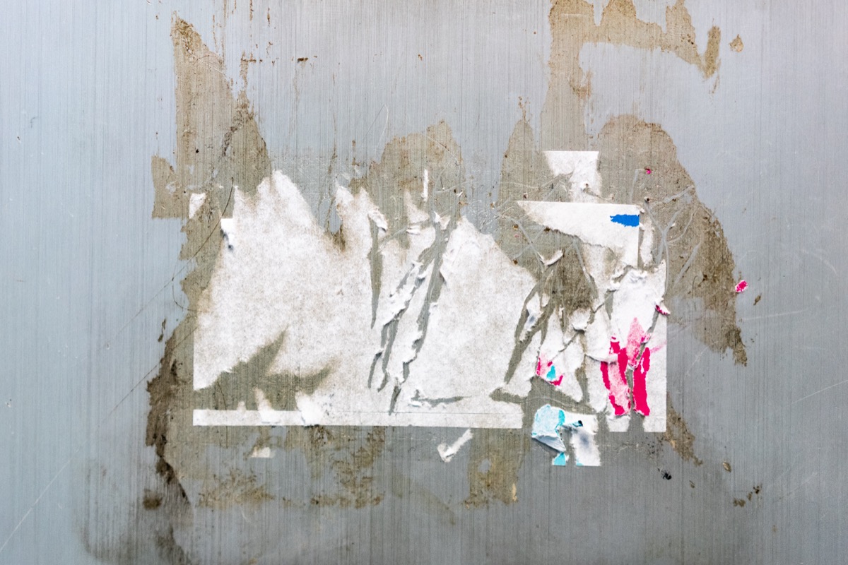 sticker trace and glue trace on grey wall texture. Perfect for background.