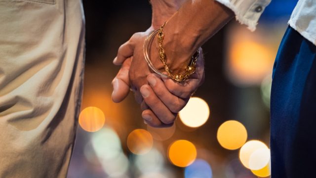 Couple holding hands at night