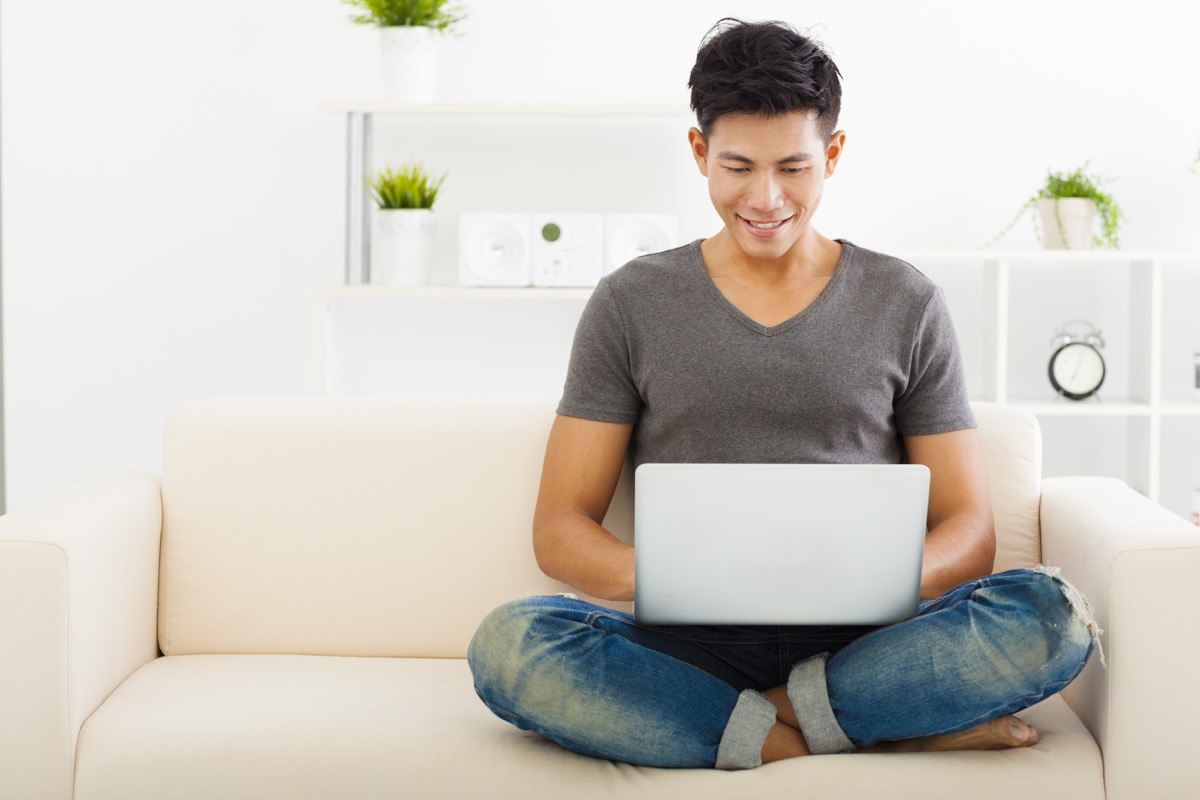 Man on laptop on couch