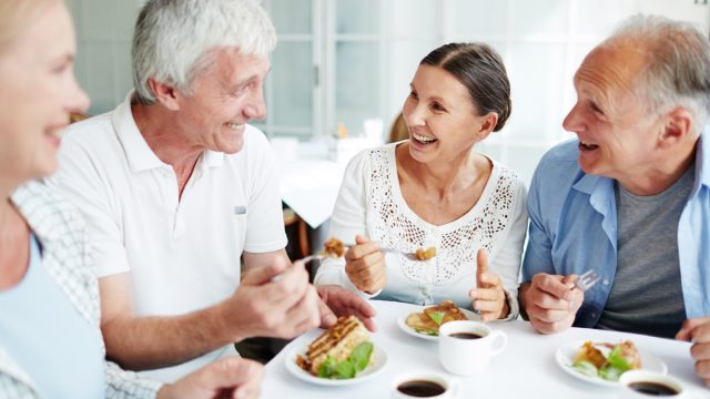 group of older white adults having lunch together
