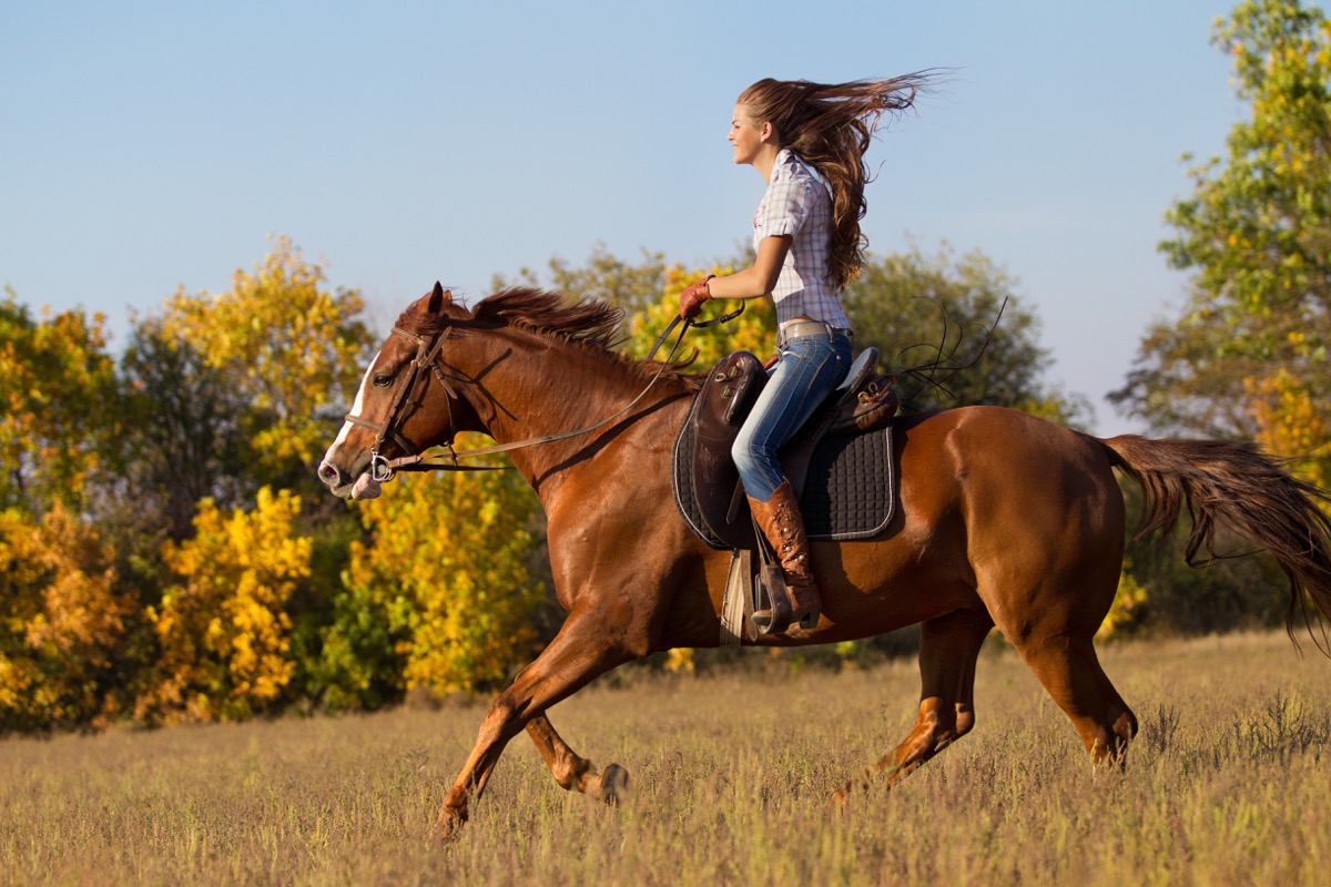 Young woman riding horse