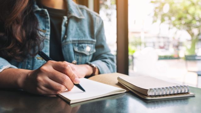 Woman writing in journal