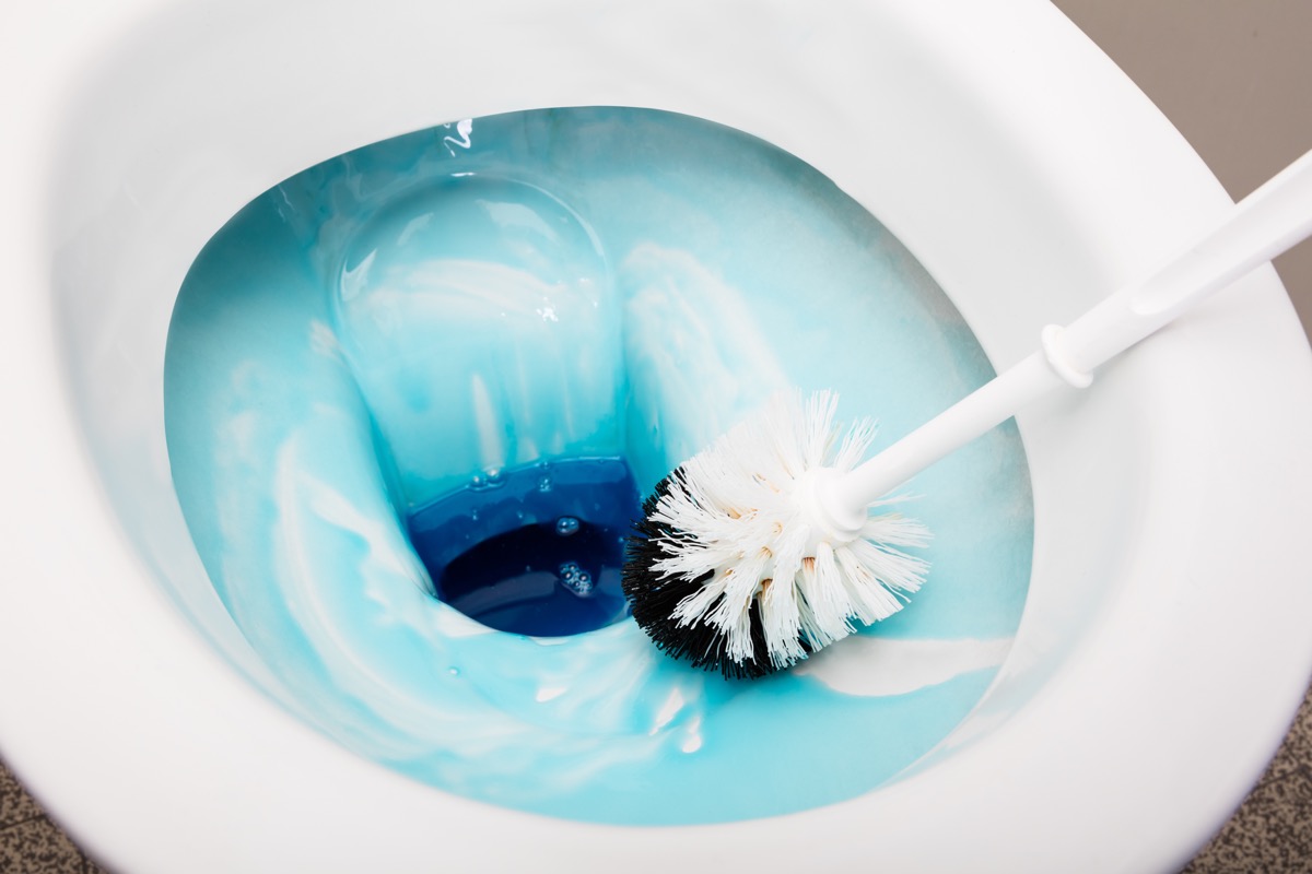 Scrubbing toilet bowl with scrubber