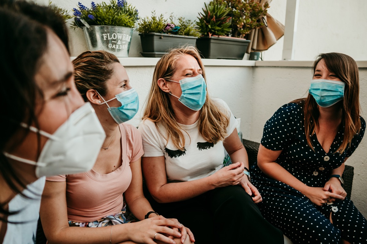 Group of friends hanging out wearing masks