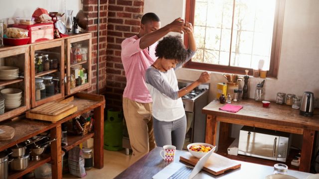 young black couple dancing in the kitchen