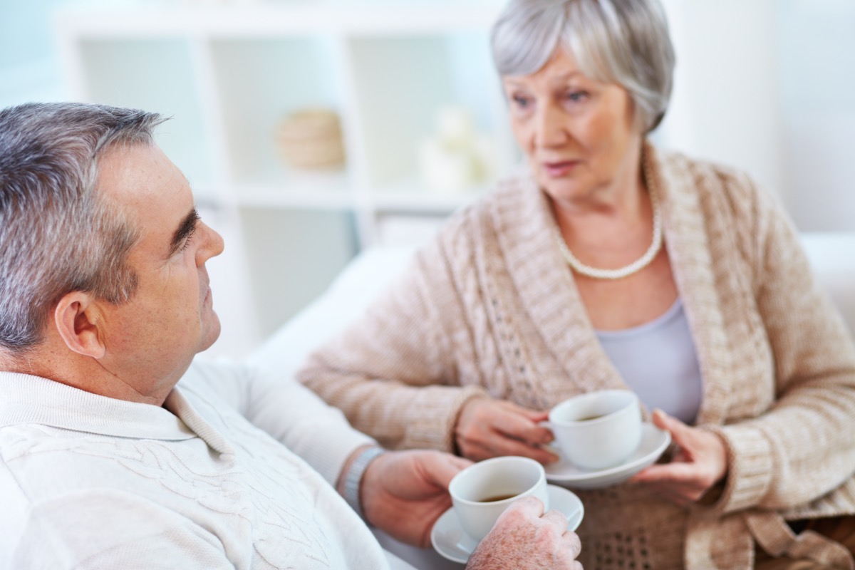 Senior man and woman talking over coffee