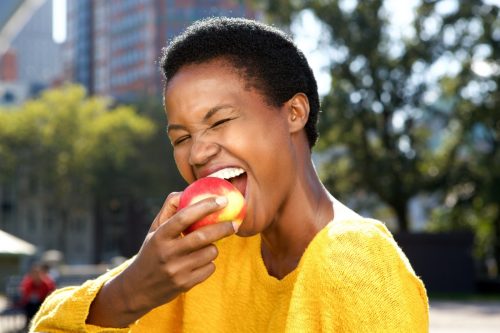 Young woman eating an apple