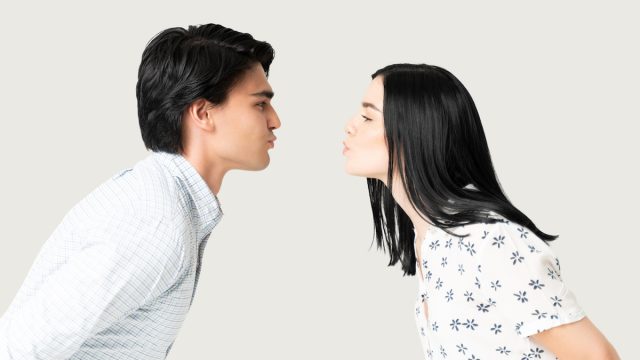 Side view of boyfriend and girlfriend puckering lips while preparing for kiss