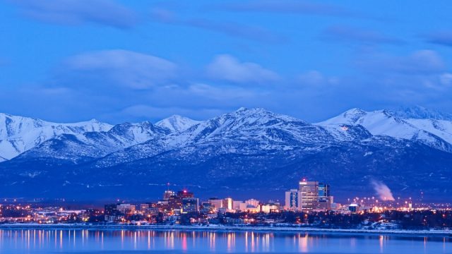 skyline photo with the Chugach mountains in Anchorage, Alaska at dusk