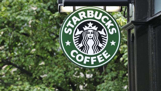 Edinburgh, Scotland - July 19, 2011: A Starbucks Coffee sign outside a Starbucks Coffee outlet on Edinburgh's Royal Mile. Starbucks Corporation is an international coffee and coffeehouse chain based in Seattle, Washington.