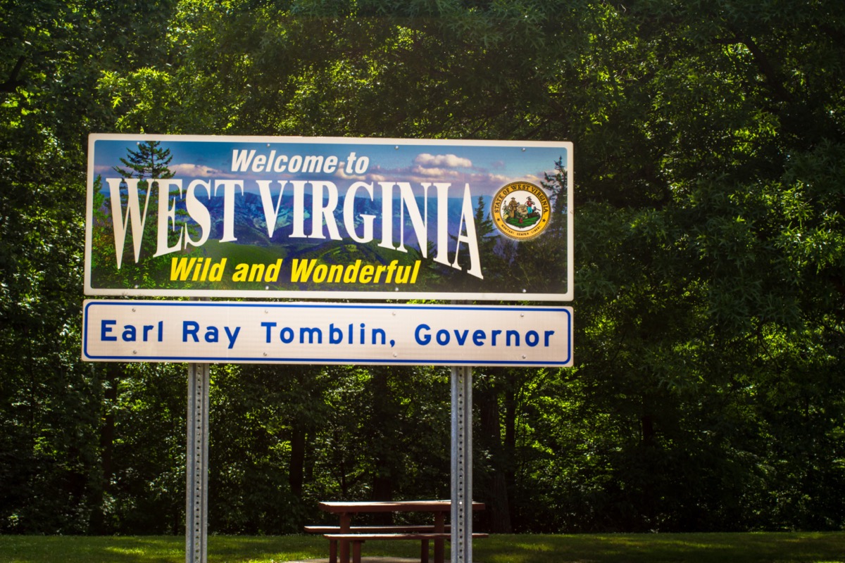 a "Welcome to West Virginia" sign in front of green trees