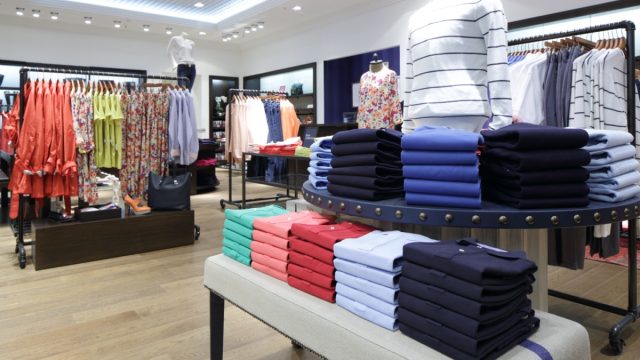 clothes folded, hung, and on mannequins in a store