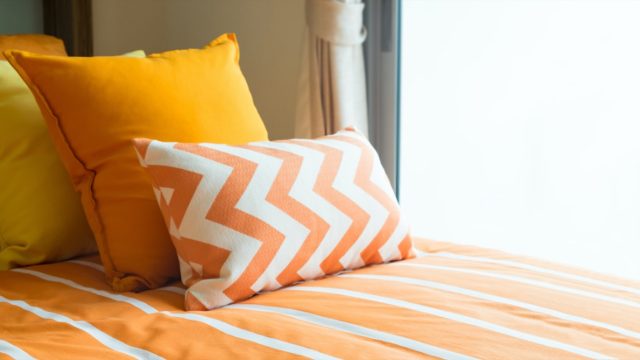 bed with colorful yellow bedding