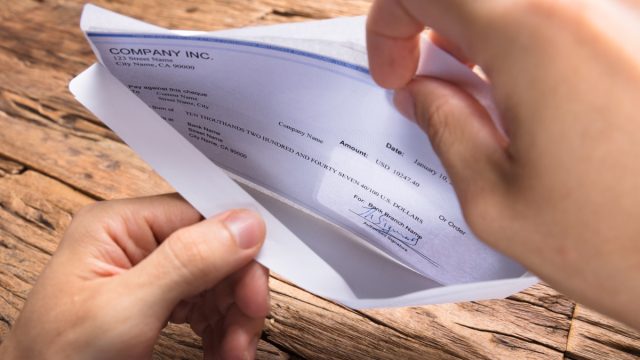 Person looking at paycheck