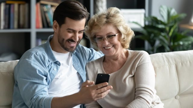 Mother and son looking at phone