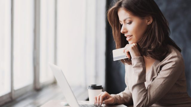 young woman shopping online with credit card