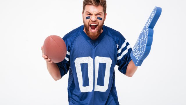 Angry bearded male fan screaming and cheering up isolated over white background